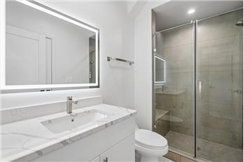 Modern, updated bathroom in this rental unit featuring contemporary fixtures and finishes.