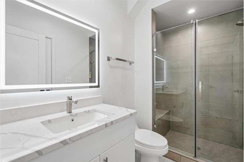 Modern, updated bathroom in this rental unit featuring contemporary fixtures and finishes.