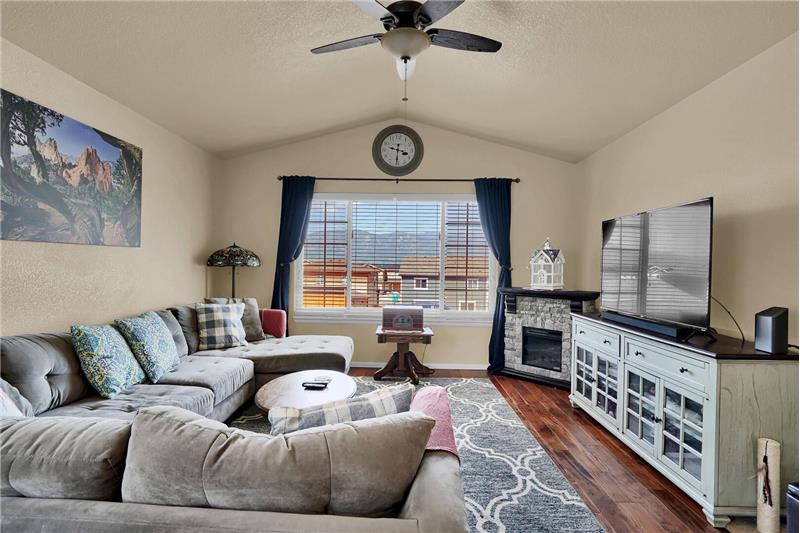 The vaulted Living Room has a lighted ceiling fan and large picture window with amazing Pikes Peak and mountain views