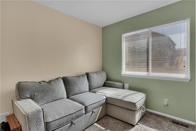 Upper-level Bedroom #2 (currently used as a study) has neutral carpet and designer paint tones