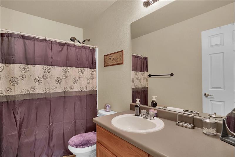 Upper-level full Hall Bathroom includes a vanity and tub/shower