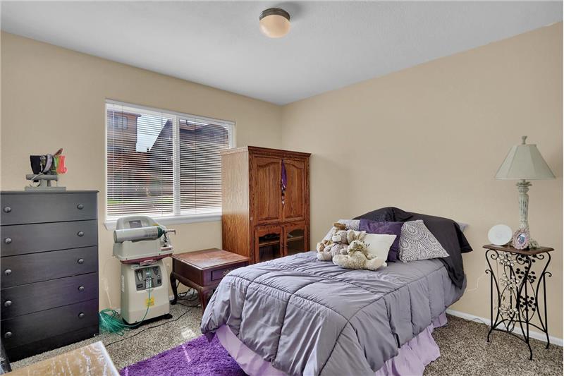 Upper-level Bedroom #3 has neutral carpet and designer paint tones