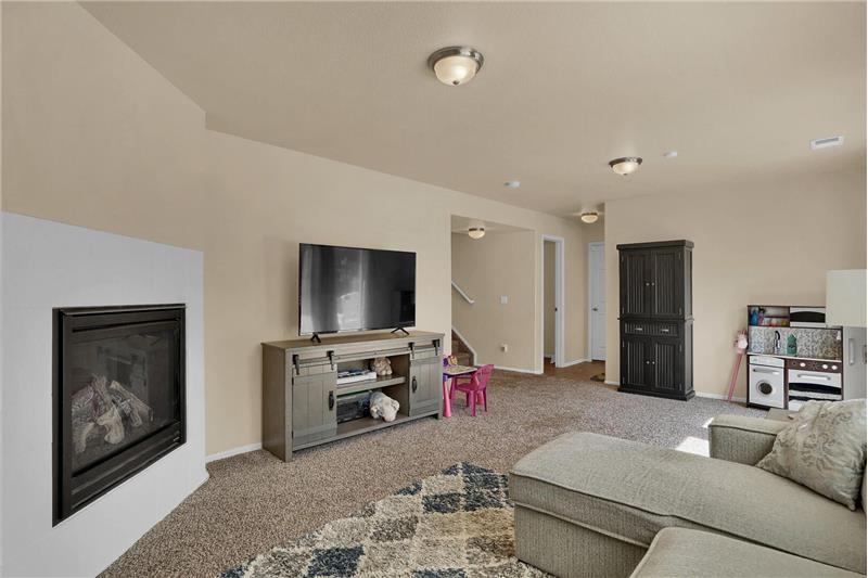 The Family Room includes neutral carpet and a gas-log fireplace
