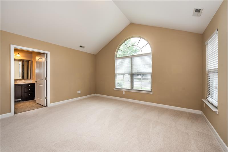 Owner's suite features brand new carpet, fresh paint, vaulted ceiling, Palladium window.