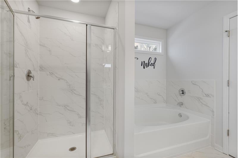 Tiled walk-in shower and large soaking tub