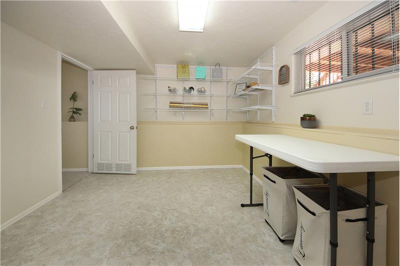 Additional space in laundry room can be used as a craft area