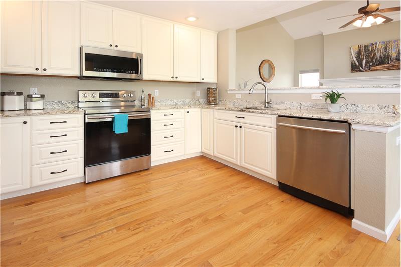 Stainless-Steel Appliances include a Dishwasher, Smooth Top Range Oven, Microwave, and French Door Refrigerator