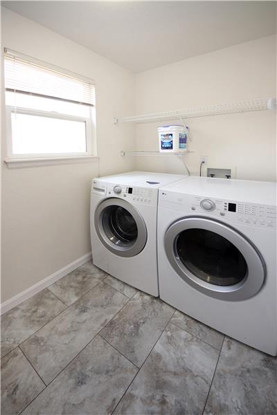 Main Level Laundry Room with Newer Floors and Washer and Dryer that Stay