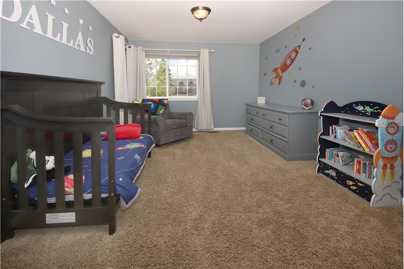 Upper Level Bedroom #2  with Neutral Carpet, Designer Paint Tones, and Pikes Peak Views