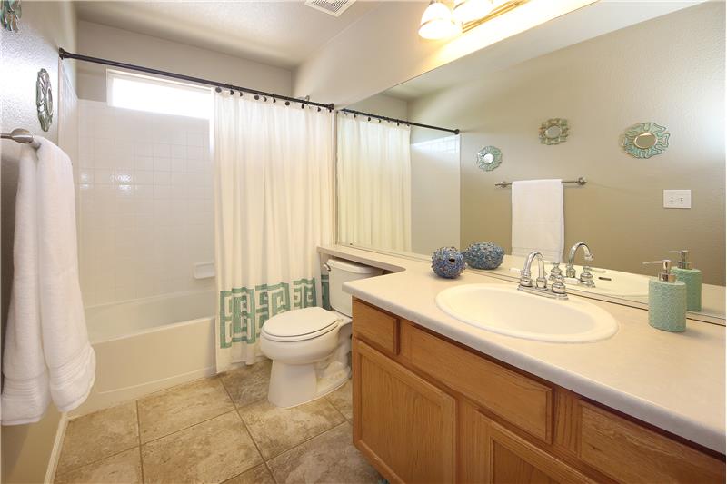 Upper Hall Bathroom with Tile Floors, Vanity, and Tiled Tub./Shower