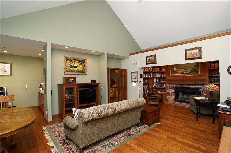 Library/den features gorgeous wood floors