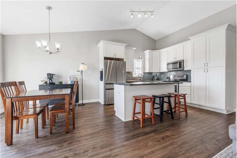 Bright white replaced kitchen, has soft close doors and drawers and some pull out shelving, tile backsplash
