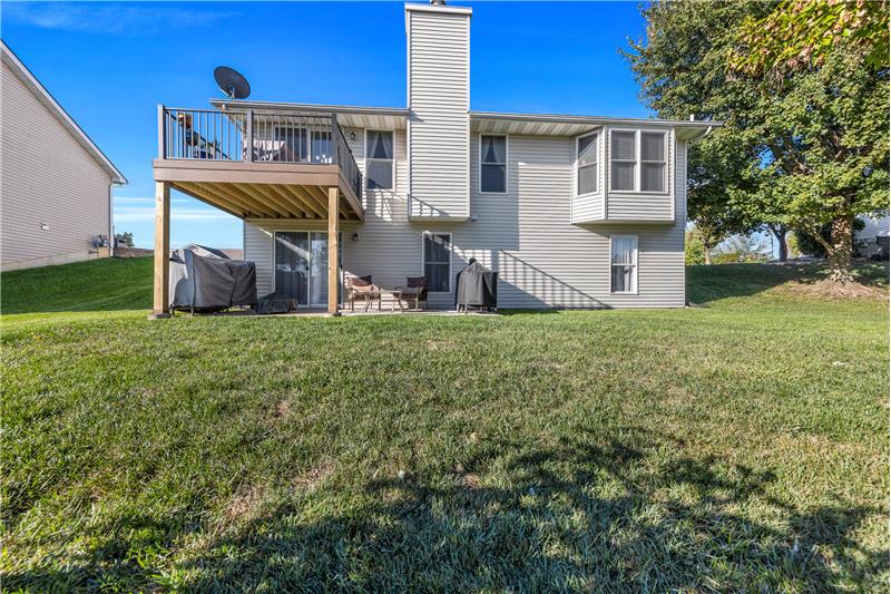 Back of home with the 10x10 composit deck and 20x10 concrete patio