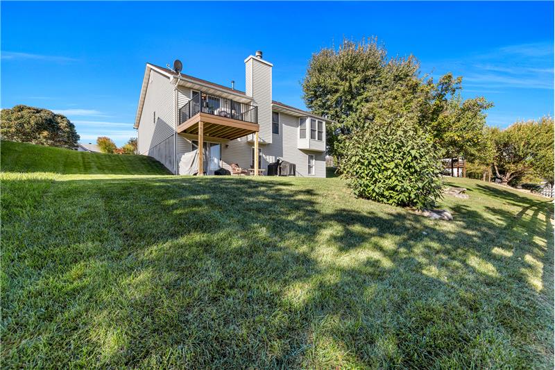 Looking at the back of home and manicured yard