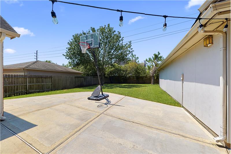 The backyard offers an extended to entertain or for your basketball needs.