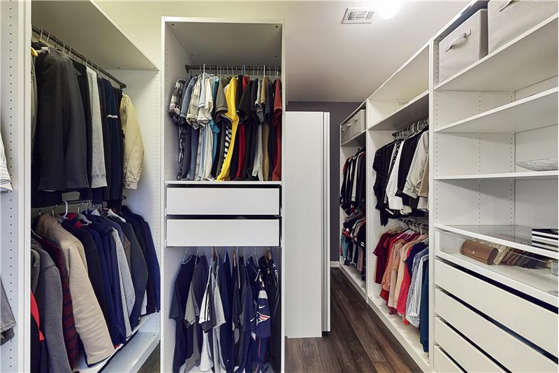 The master closet is spacious with custom shelving.