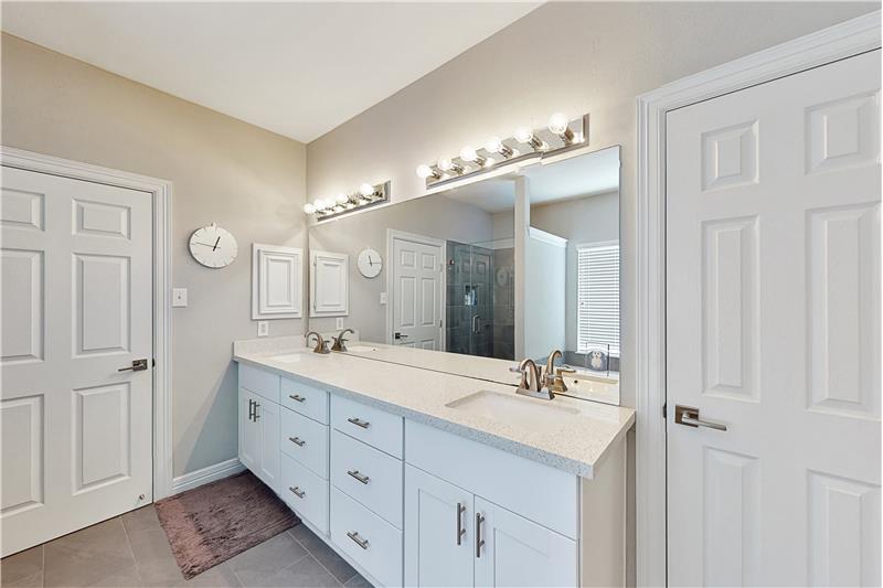 The master bath has plenty of counter space and drawers for all your needs.