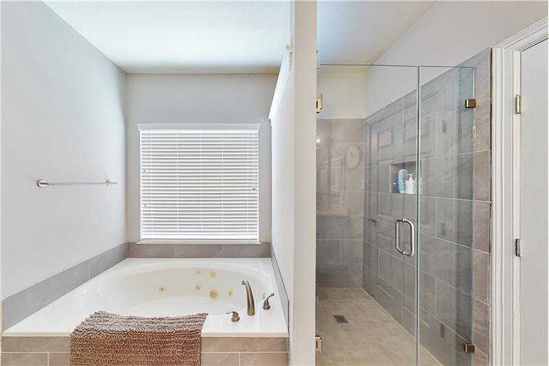 The master bath has a whirlpool bathtub and large walk in shower.