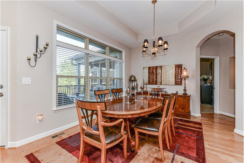 Triple windows in dining room provide great natural light and views of the private deck.