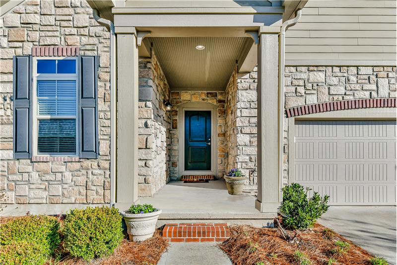 Covered entry protects from the elements. Stacked stone veneer front. Easy maintenance fiber cement siding.