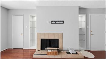 Built in shelves around wood burning fireplace