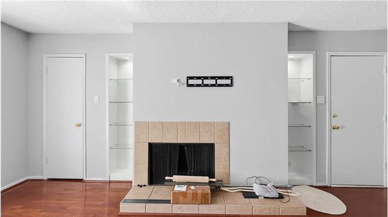 Built in shelves around wood burning fireplace