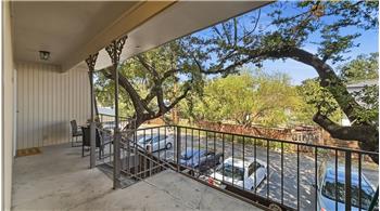 Back entry with covered porch and back stairs to parking. 2 designated spots