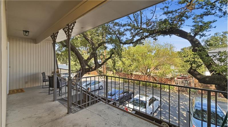 Back entry with covered porch and back stairs to parking. 2 designated spots