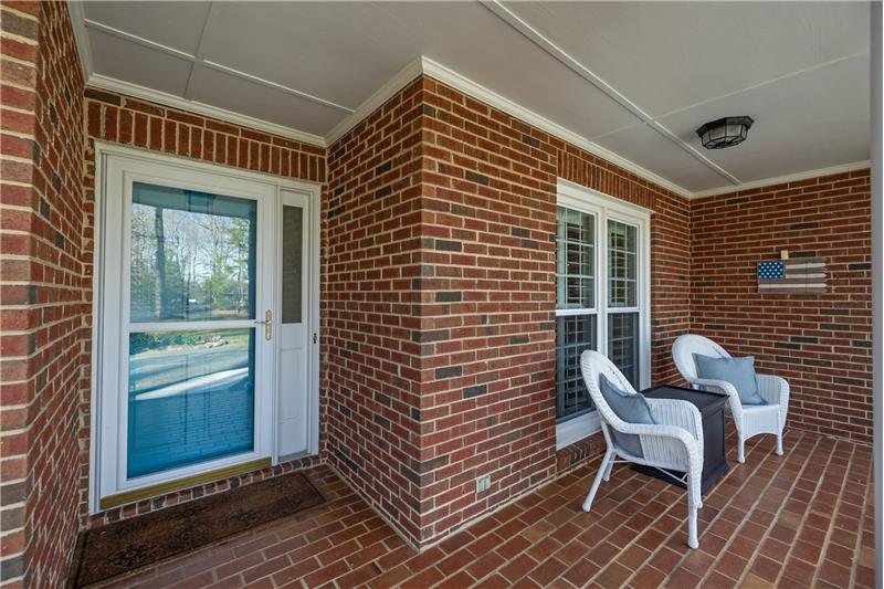 Welcoming entry and covered front porch set the tone for the home's warm and well-kept interior.