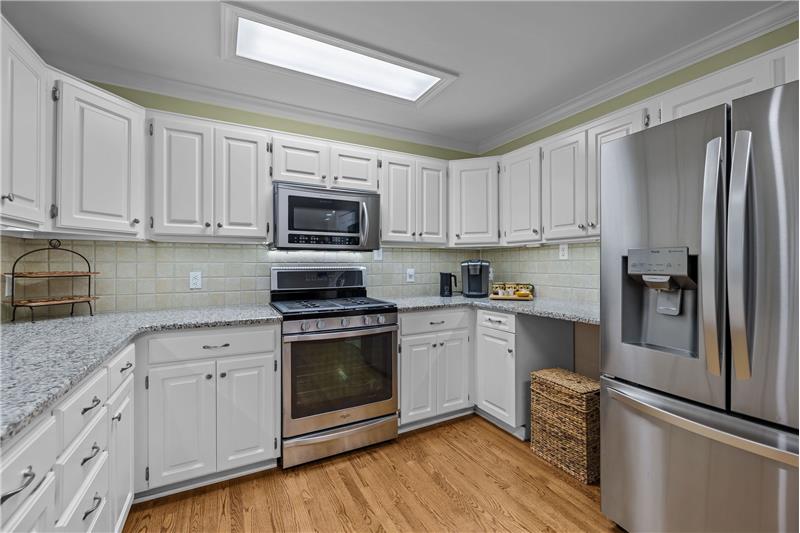 Kitchen features gas range, built-in microwave, French-door refrigerator, dishwasher, tile backsplash, pantry.
