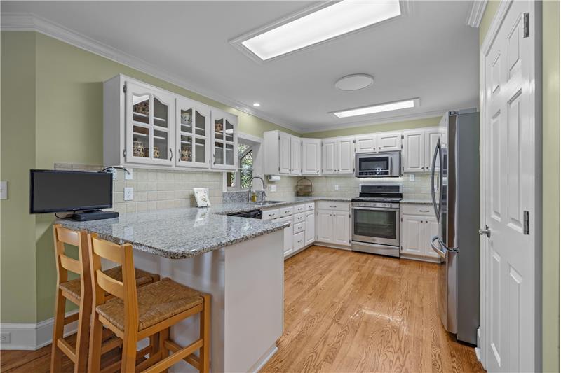 Kitchen's peninsula overhang adds convenient counter seating. 