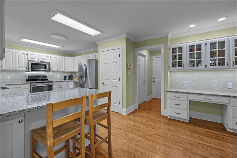 Lots of storage cabinets, counter space, and a planning desk.
