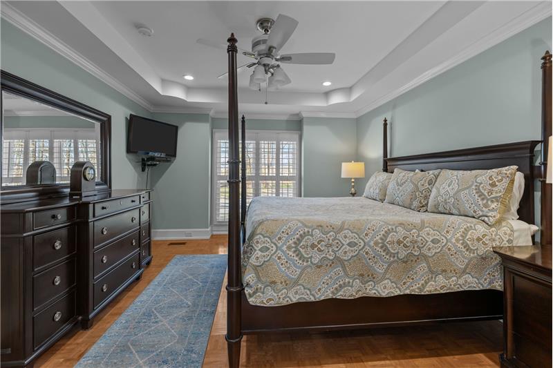 Situated on home's main floor, primary suite has room for king-size bed, large dresser.
