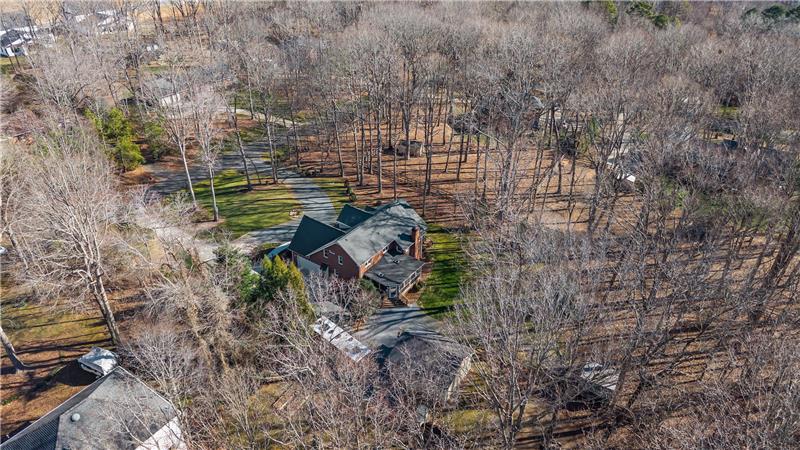 Aerial view: A natural buffer of woods creates a peaceful sense of space and separation.