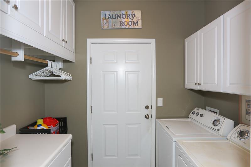 Laundry room with added cabinets on both sides.