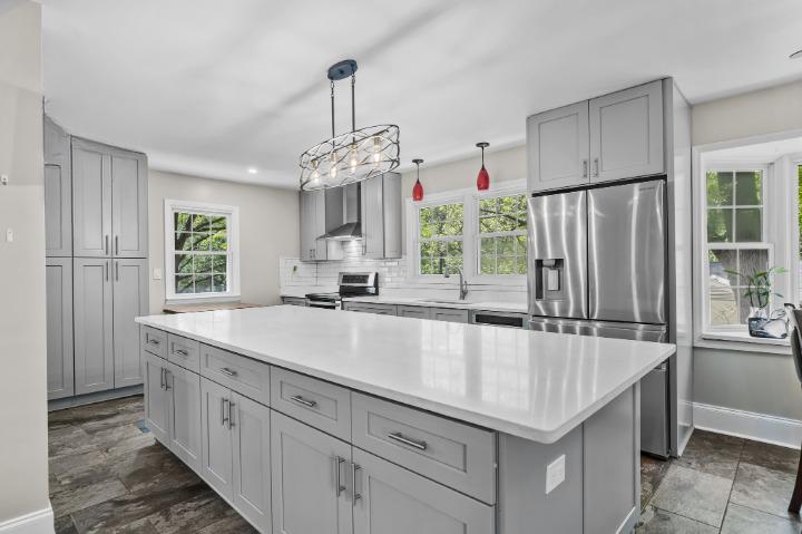 Renovated kitchen with huge island, shaker style cabinets