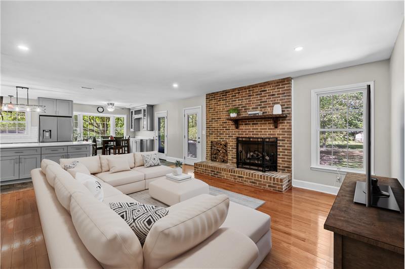 Great room with brick fireplace, hardwood floors