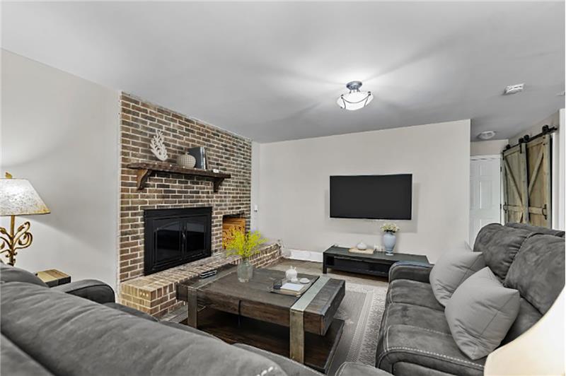 Large family/entertainment room with brick fireplace