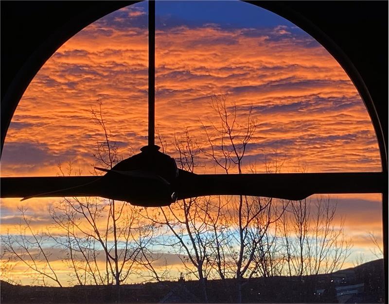 Sunrise viewed through great room window from loft