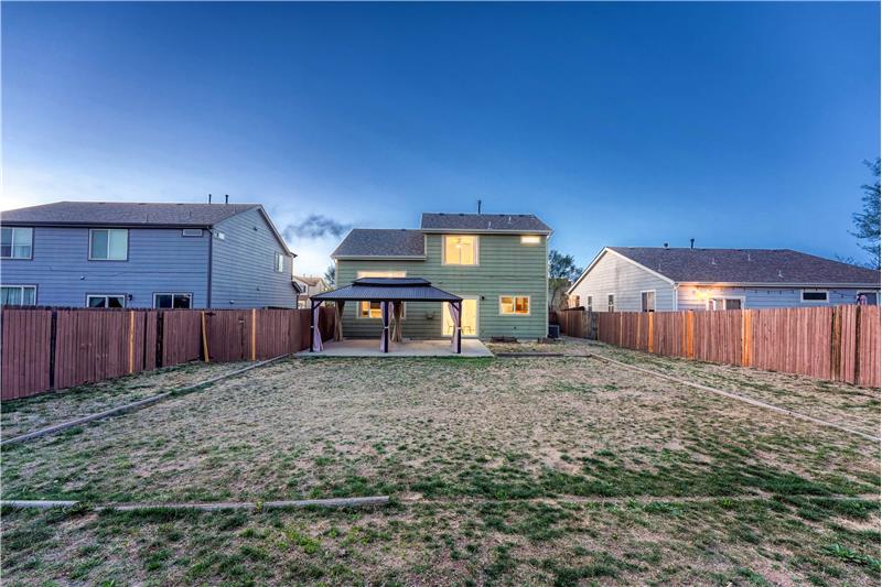 Large and level, fenced backyard with patio