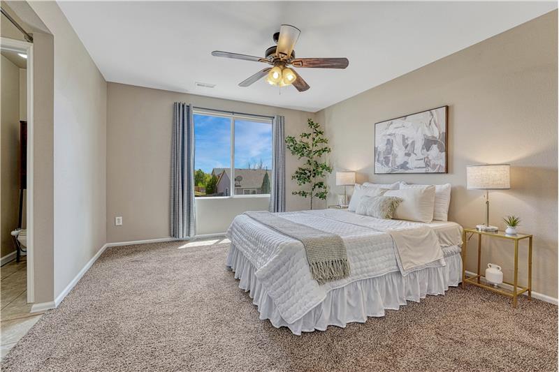 Primary bedroom with ceiling fan