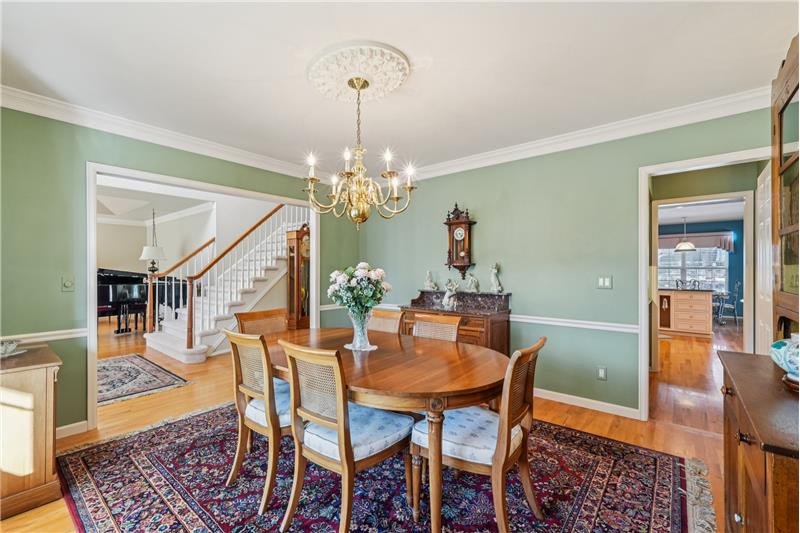 Formal dining room with butler's pantry at right and kitchen beyond