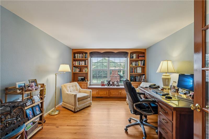 Upstairs office with window seat and built-in shelving