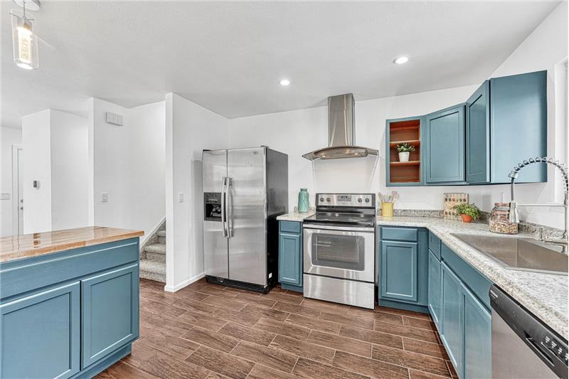 SS Appliances include a Dishwasher, Smooth Top Range Oven, Vent Hood, and Side by Side Refrigerator