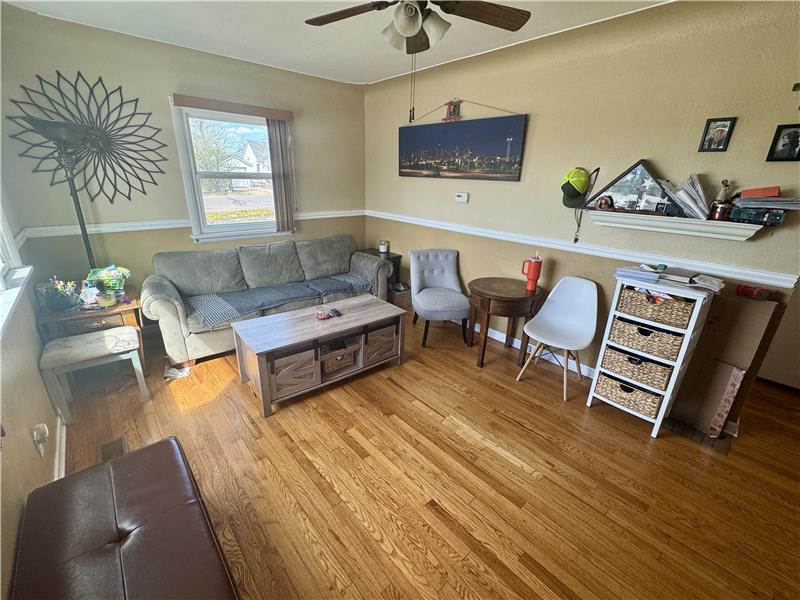 Living room viewed from front door. Great paint and hardwood floors!