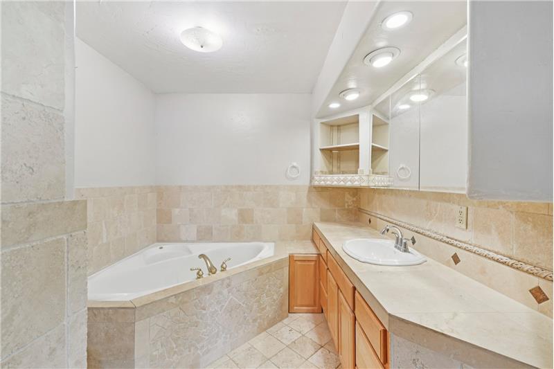 Primary suite's ensuite bath with jetted tub and separate shower (off-camera)