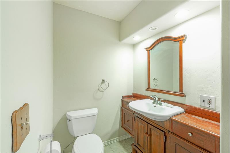 Half bath across hall from primary suite with door to office