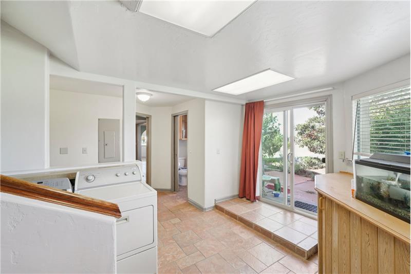 Laundry room viewed from door to garage, showing door to patio