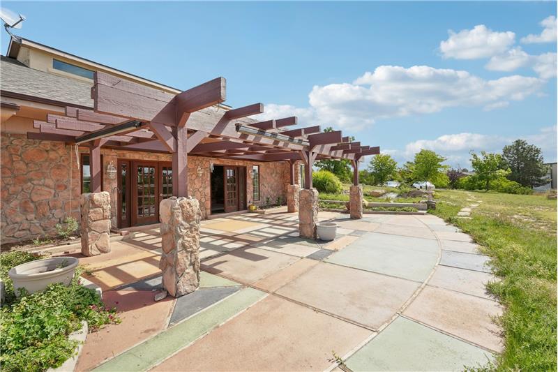 Patio outside living room with pergola