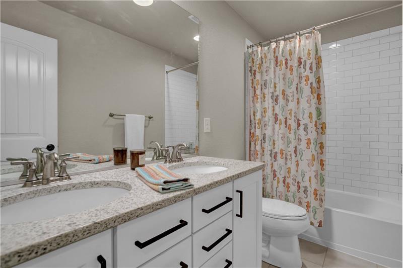 Upper Level Hall Bathroom with Dual Sink Vanity & Tiled Tub/Shower